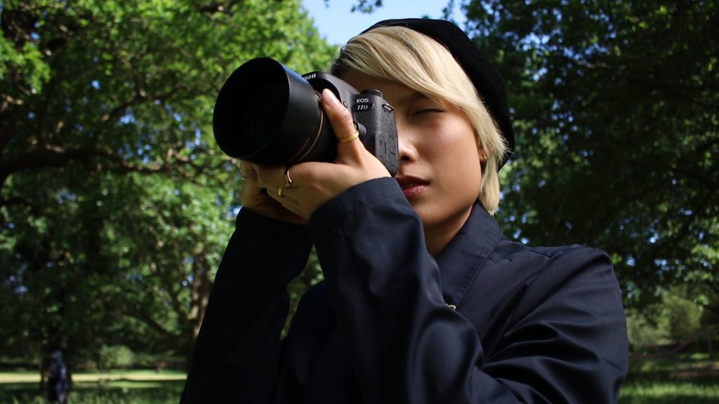 Canon 77D with the Canon EF 50mm f1.4 lens, held by a female model