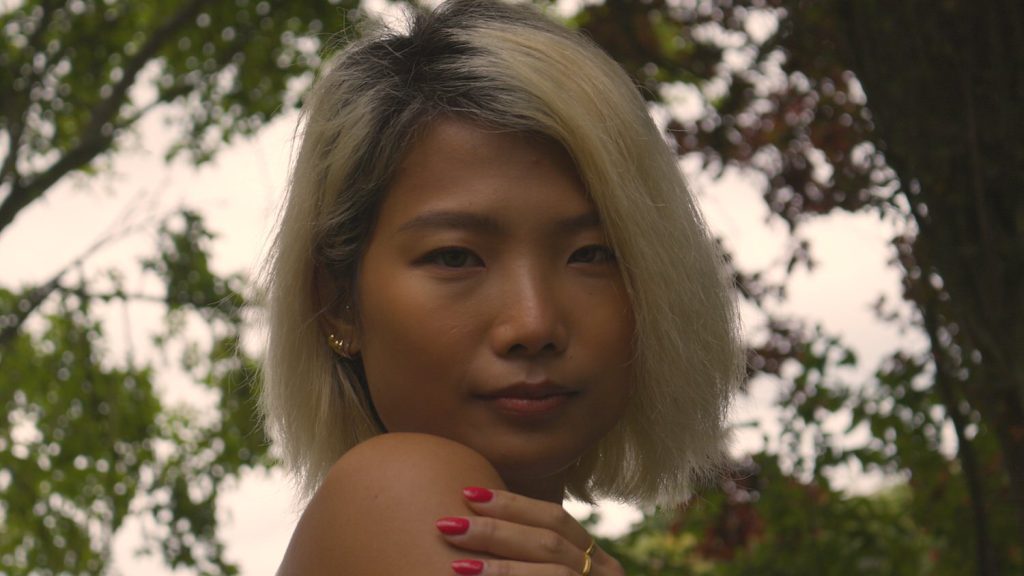 Female model, screenshot taken from video filmed with the Canon R5, and the Canon EF-S 18-55mm lens